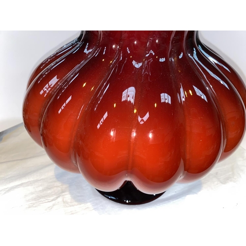 426 - Petr Novotný:  a large hand made glass vase of bulbous form in red over white, on flared foot, heigh... 