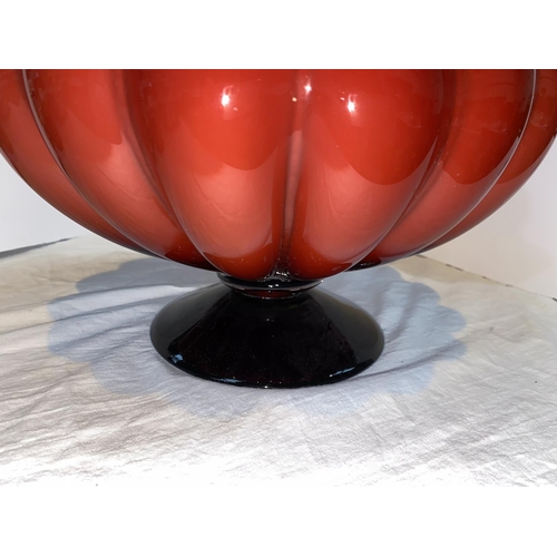 426 - Petr Novotný:  a large hand made glass vase of bulbous form in red over white, on flared foot, heigh... 