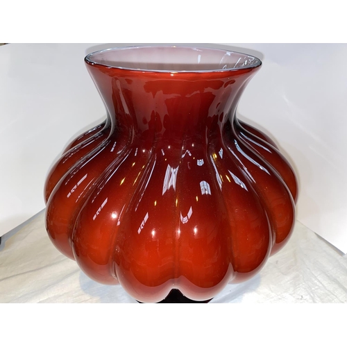 426 - Petr Novotný:  a large hand made glass vase of bulbous form in red over white, on flared foot, heigh... 