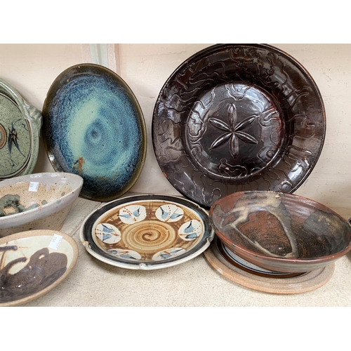 354 - A selection of glazed and unglazed Studio pottery dishes, some monogrammed