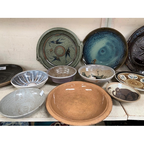 354 - A selection of glazed and unglazed Studio pottery dishes, some monogrammed