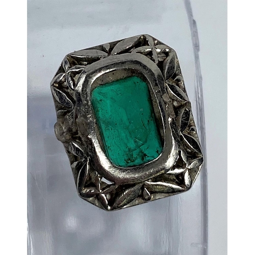 573 - A rectangular cushion cut emerald coloured stone, surrounded by small diamonds.