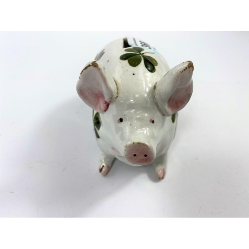 366 - A Wemyss piggy bank, decorated in the clover pattern, marked 'WEMYSS' to base, 9.5cm high, 16cm long