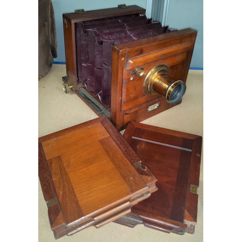 131b - A Dollond of London mahogany cased plate camera and plates.