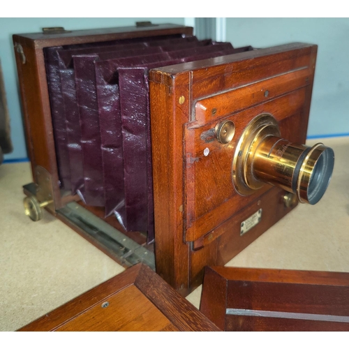 131b - A Dollond of London mahogany cased plate camera and plates.