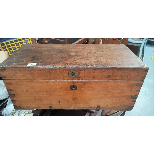 142 - A small antique stained wood campaign chest with brass corners.