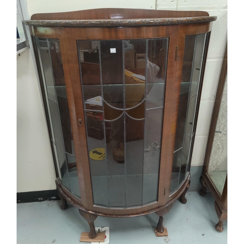 680C - A 1930's walnut display cabinet enclosed by coloured leaded glass doors