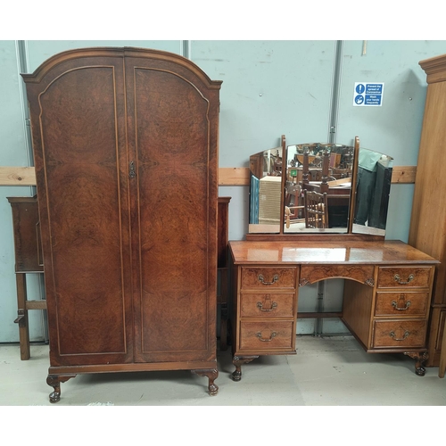 693 - A burr walnut bedroom suite in the Queen Anne style comprising part fitted wardrobe, kneehole dressi... 