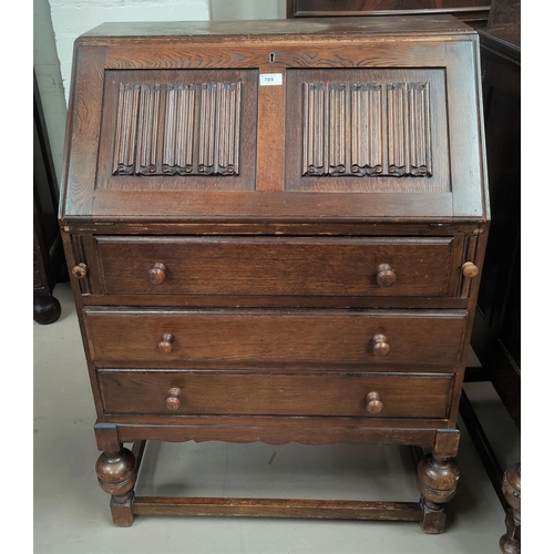 709 - A 1930's oak bureau with fall front and 3 drawers