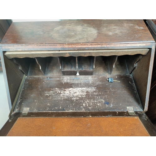 709 - A 1930's oak bureau with fall front and 3 drawers