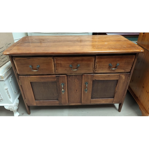 747 - A stained pine side cabinet; a similar smaller cabinet