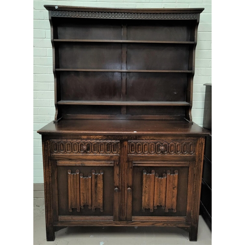 759 - A near matching reproduction oak dining suite with carved and linen fold decoration comprising round... 