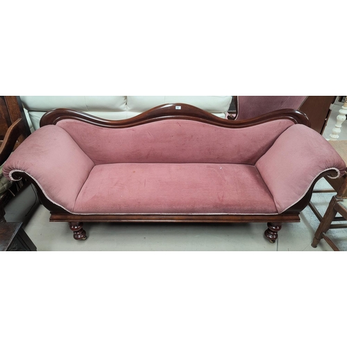 768 - A Victorian double scroll end mahogany settee on turned legs and castors in pink dralon
The approxim... 