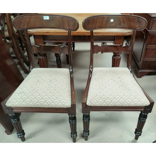 774 - An early 19th century set of 4 mahogany dining chairs with wide top rails, drop in seats in brown, o... 