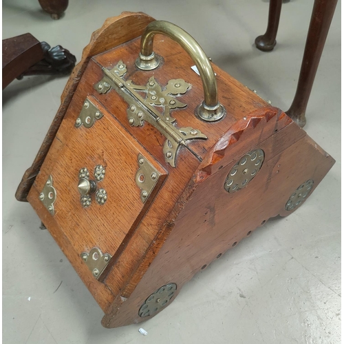 779 - An Edwardian Golden Oak fall front coal box with ornate brass handle and mounts