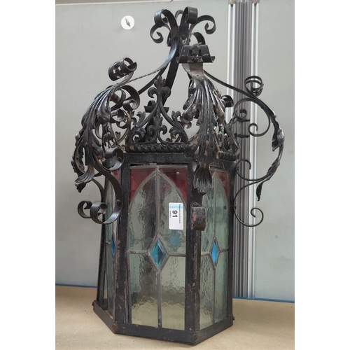 91 - A cast metal hall light in the Gothic manner with 6 various leaded glass panels