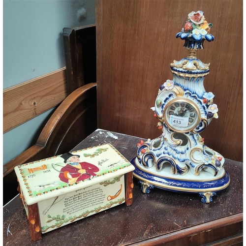 413 - A porcelain reproduction French quartz mantel clock, blue and gilt with floral decoration and a John... 