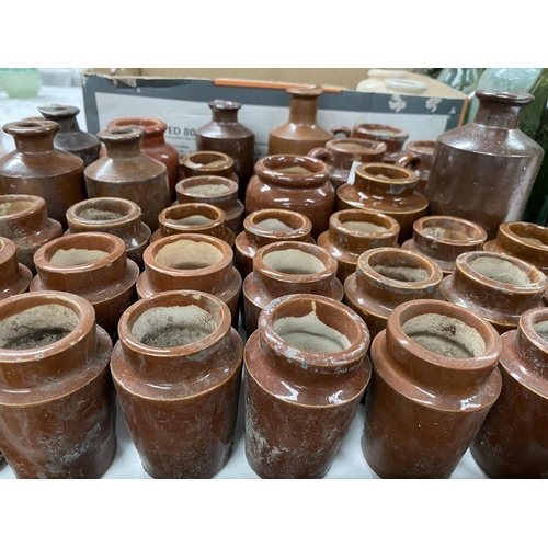 432 - A large selection of small stoneware jars; bottles including cream pots  etc.