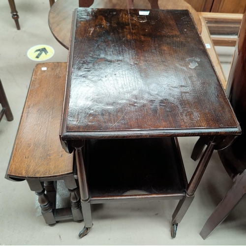 713 - An oak 2 tier tea trolley with oval drop leaf top; an oak drop leaf occasional table