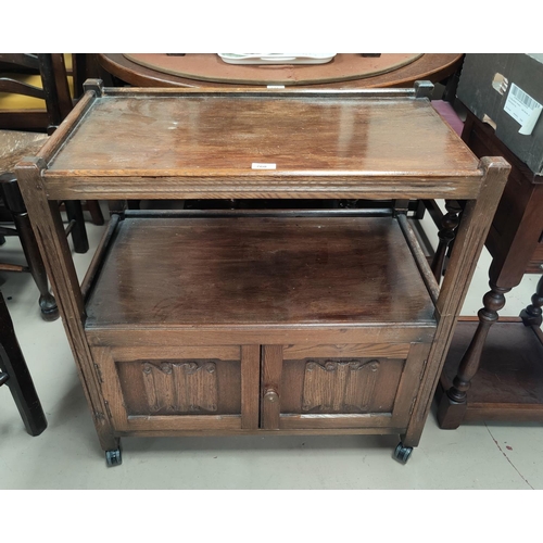 760 - A reproduction oak 2 tier tea trolley with cupboard under