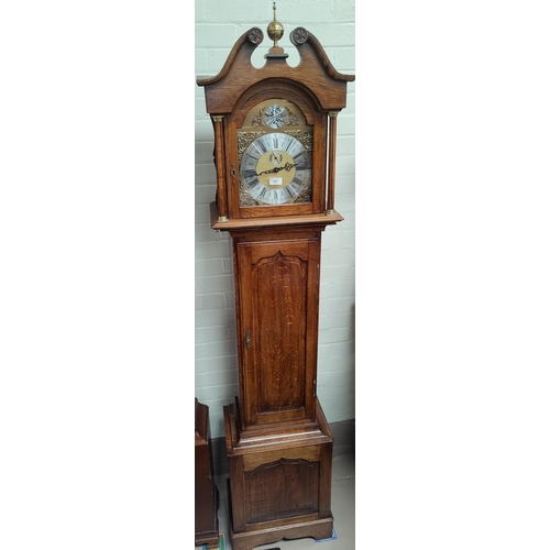 761 - A period style oak longcase clock with brass dial and fielded panel door with triple weight driven c... 