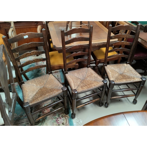 778 - A matched set of 5 country made rush seat ladder back dining chairs