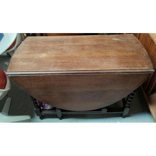 789 - An oak barley twist drop leaf dining table.