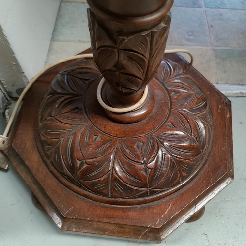 792 - A carved oak standard lamp on carved on carved octagonal base.