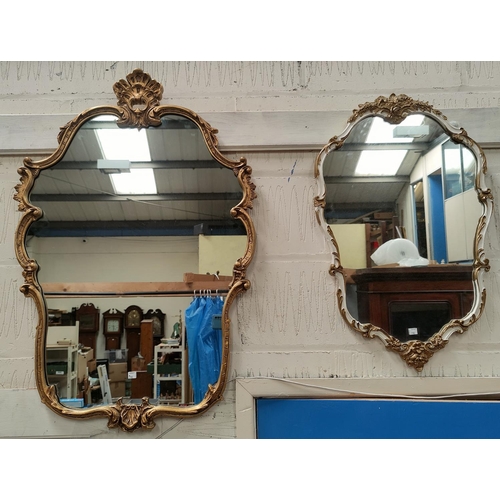 798 - A gilt framed classical shield shaped mirror, height 94cm; another smaller white and gilt mirror