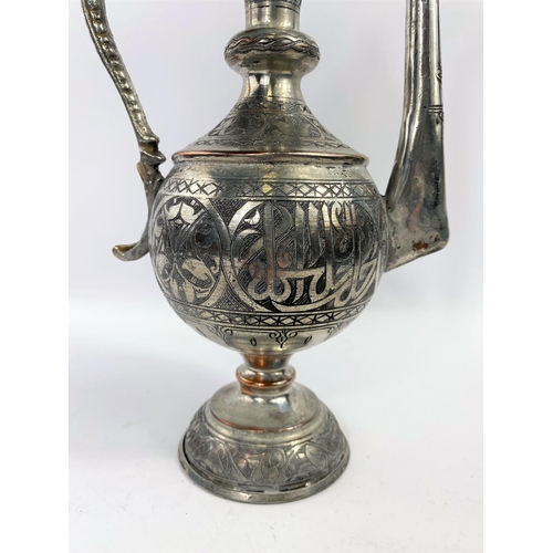 576 - A Middle Eastern silver on copper teapot ewer with animal decoration etc ht 34cm and a brass and cop... 