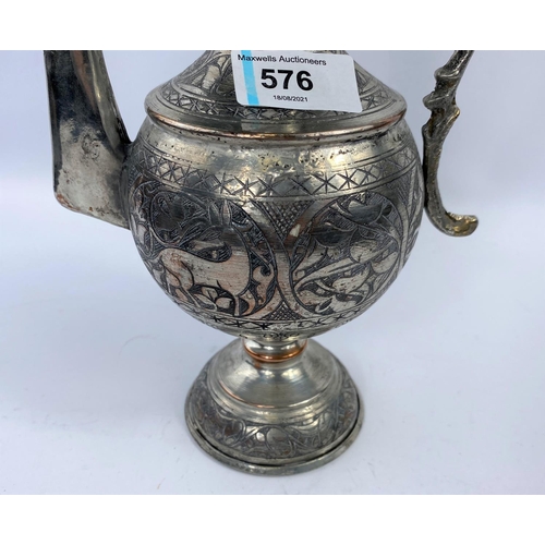 576 - A Middle Eastern silver on copper teapot ewer with animal decoration etc ht 34cm and a brass and cop... 