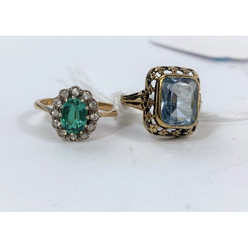 570 - A yellow metal dress ring stamped 9ct set with central green stone, surrounded by clear stones, 2.4g... 