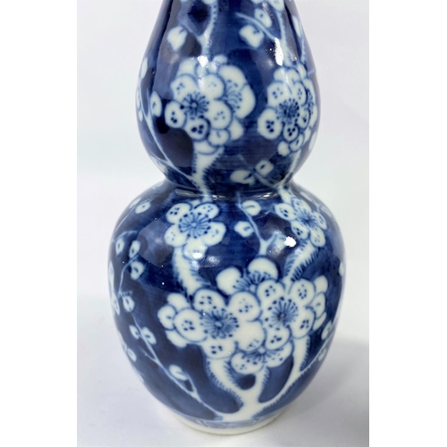 312 - A 19th century Chinese blue and white double gourd vase, prunus blossom decoration, h. 19cm (rim a.f... 
