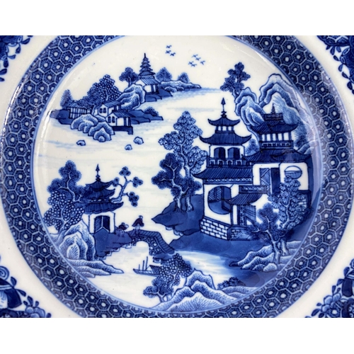 313 - An 18th century Chinese shallow bowl with detailed decoration of traditional mountain scene, with sc... 