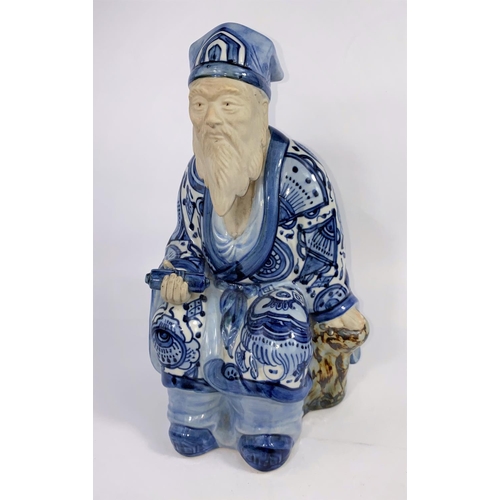 316A - A Japanese blue and white figure of a scholar seated in robes with scroll, ht. 30cm (hand a.f.)(Good... 