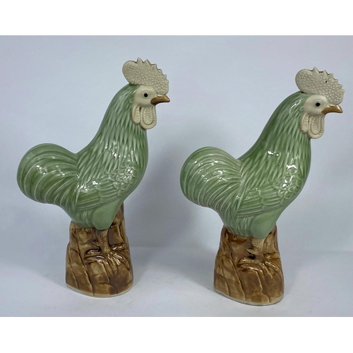 319 - A pair of Chinese cockerels, ht. 24cm (Both in good condition)