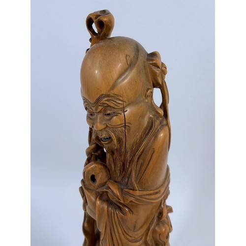 320 - A Chinese carved wood figure of a sage, ht. 24cm (Finely carved rootwood, some cracks notably to fac... 