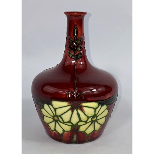 401 - A late Minton bottle vase, tube lined floral decoration on red ground, No. 32, 12cm