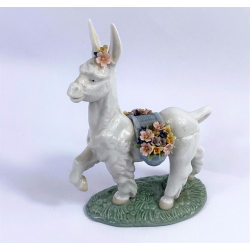 403D - A Lladro figure of a Donkey draped in flowers No/6573 height 17cm.
