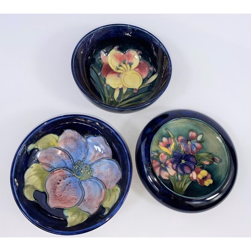 426 - Three Moorcroft small circular dishes decorated respectively with hibiscus, freesia and orchid, all ... 