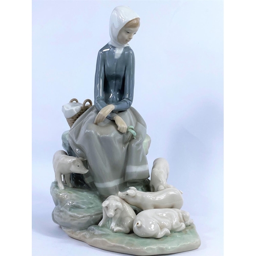 434 - A Lladro group:  seated girl and pigs, height 28 cm