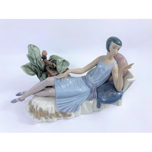 456 - A Lladro group:  1920's girl on chaise longue with gramophone (a.f.)