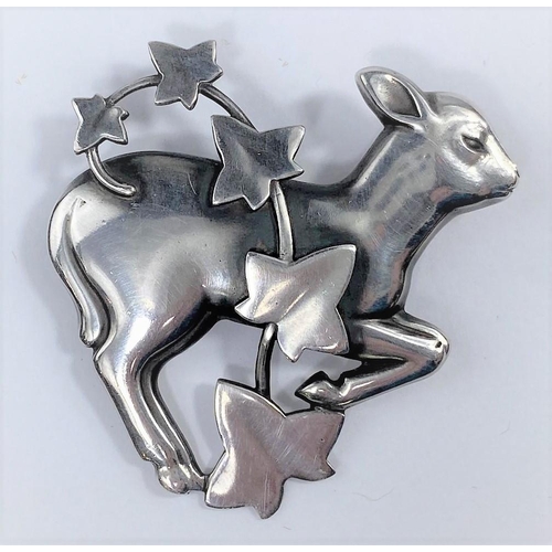 492 - A Georg Jensen silver brooch designed by Arno Malinowski:  a gambolling lamb with strand of ivy, No ... 