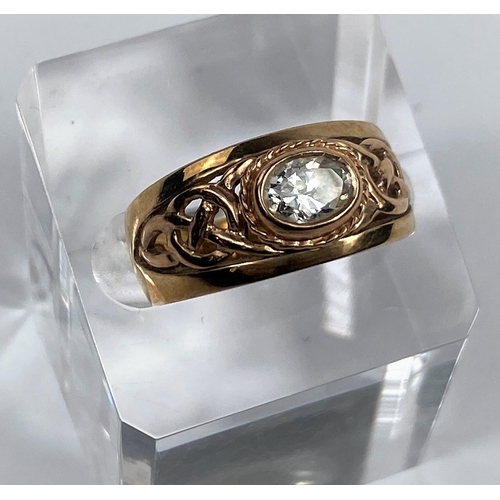 508 - A 9 carat hallmarked gold period style ring set clear oval stone, the split shank with pierced decor... 