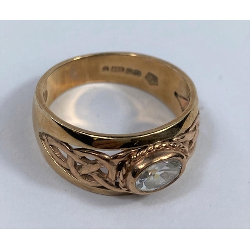 508 - A 9 carat hallmarked gold period style ring set clear oval stone, the split shank with pierced decor... 