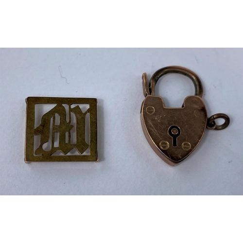 555 - A 9 carat hallmarked gold heart lock; a yellow metal pierced 'M' link, stamped '9ct', 3.9 gm