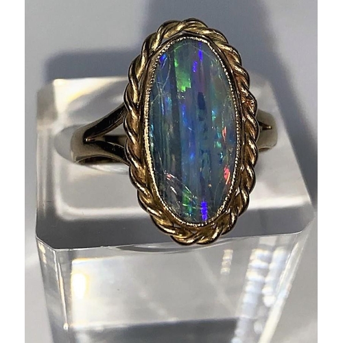 587 - A 9 carat hallmarked gold ring set large opal coloured stone (stone cracked), 4.6 gm