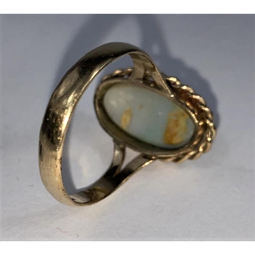 587 - A 9 carat hallmarked gold ring set large opal coloured stone (stone cracked), 4.6 gm