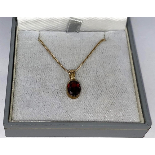 590 - A 9 carat hallmarked gold garnet set pendant, boxed; a 9 carat hallmarked gold chain, 5.1 gm gross