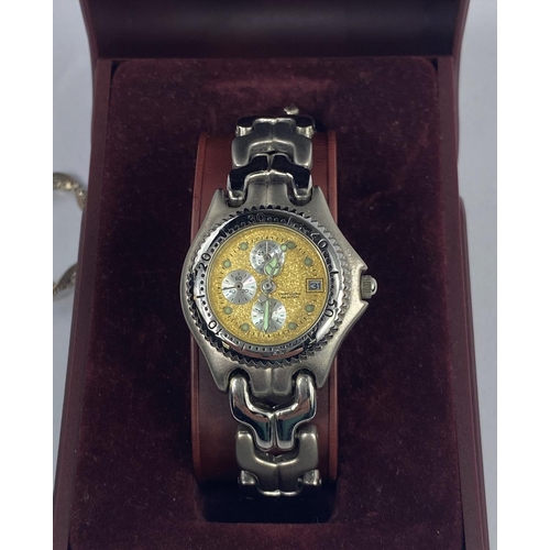 590A - A lady's stainless steel wristwatch with a gilt face & 3 secondary dials; a smoky quarts pendant in ... 